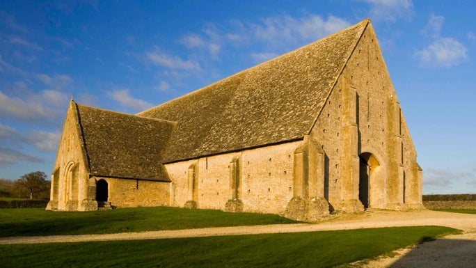 Exterior of Great Coxwell Barn against a blue sky